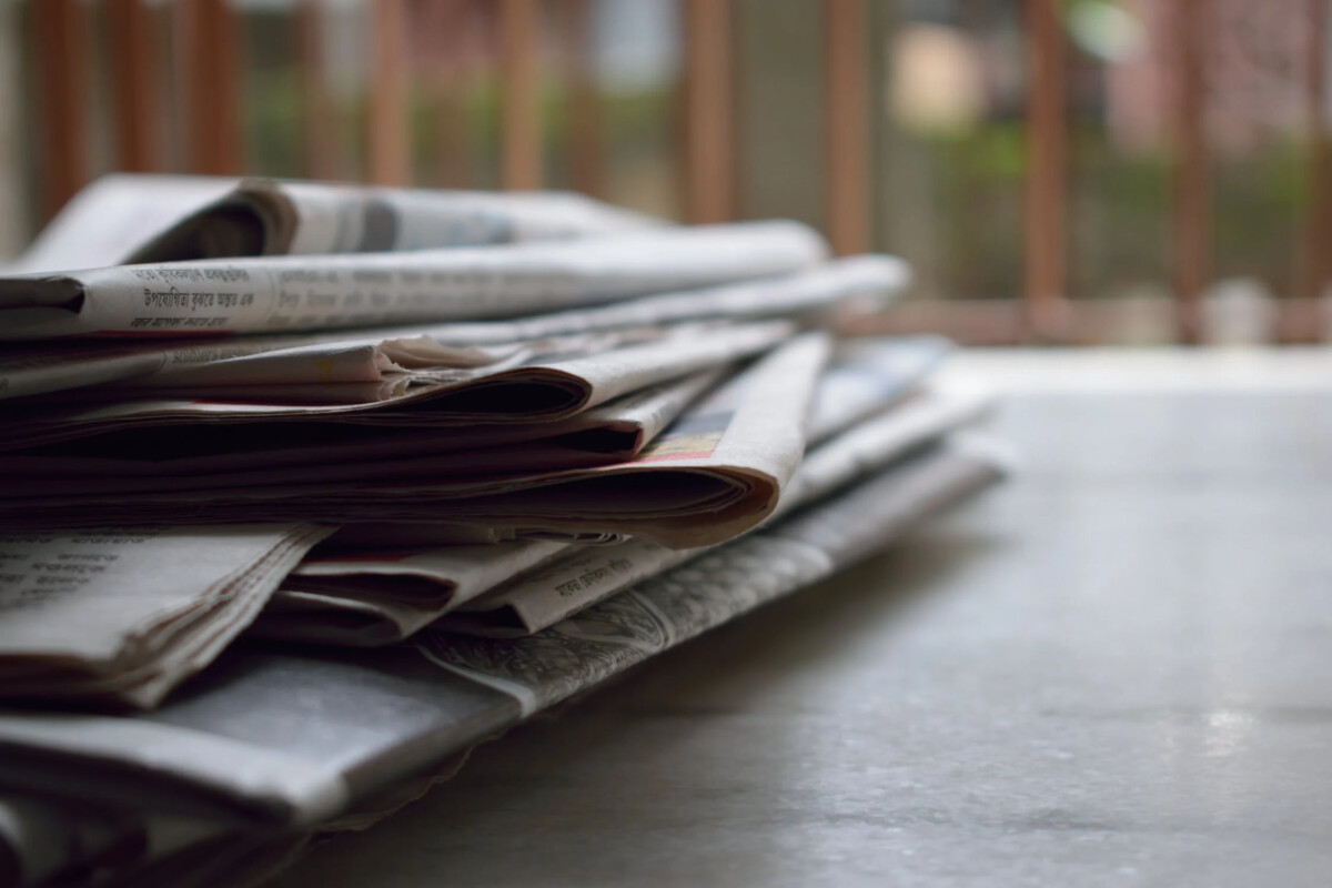 A stack of printed newspapers